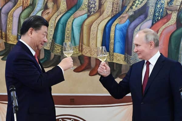 Chinese president Xi Jinping and Russia's Vladimir Putin toast each other during a reception in Moscow in March (Picture: Pavel Byrkin/Sputnik/AFP via Getty Images)