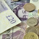British currency, pound coins and banknotes. The UK's economic outlook is improving, but trade challenges remain.