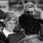 A still from The Princess: Diana, Princess of Wales is surrounded by police and security as she arrives for a visit to Harlem Hospital's pediatric AIDS unit in Harlem New York, February 1989