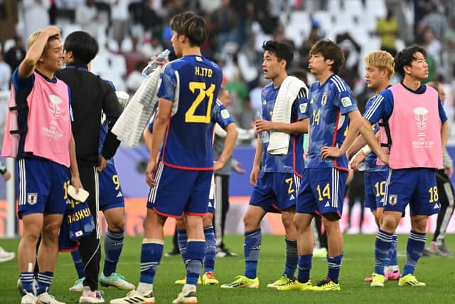 Japan's players look on disbelief after losing 2-1 to Iraq at the Asian Cup.