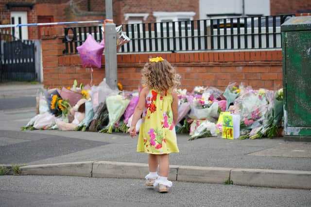 A young girl lays a tribute in Kingsheath Avenue in Knotty Ash, Liverpool, where nine-year-old Olivia Pratt-Korbel was fatally shot on Monday night. Picture: Peter Byrne/PA Wire