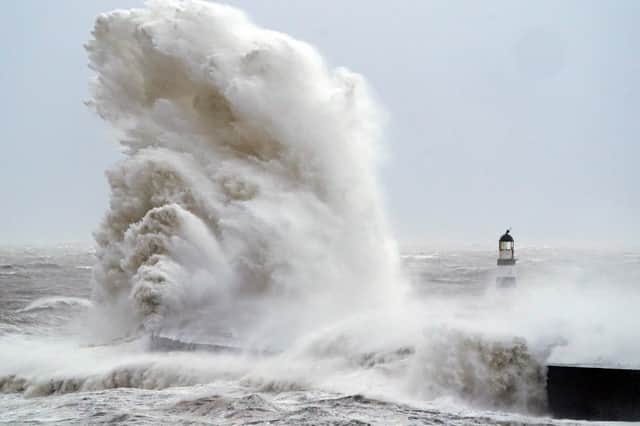 Huge waves crash against the lighthouse in Seaham Harbour, County Durham, in the tail end of Storm Arwen