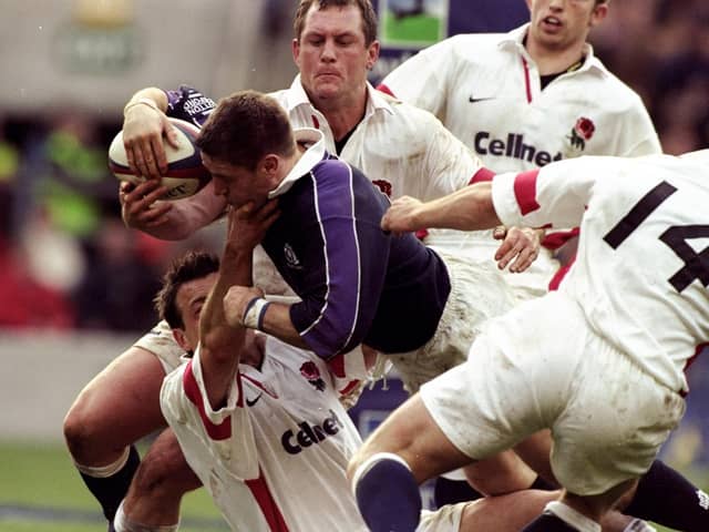 Alan Tait of Scotland forces his way over to score against England in the Calcutta Cup Five Nations match at Twickenham in 1999.