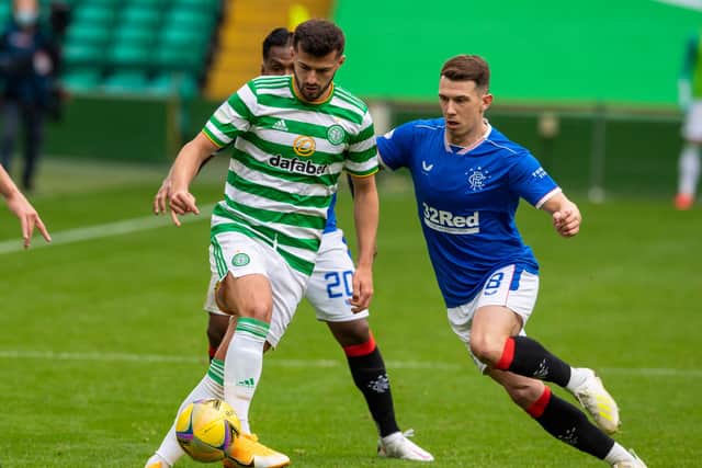 Celtic's Albian Ajeti (left) holds off Rangers' Ryan Jack.