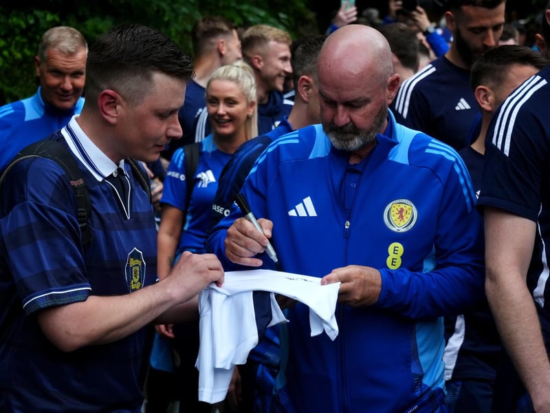 Scotland manager Steve Clarke signs a shirt for a fan as he arrives at Bayernhalle in Garmisch-Partenkirchen, Germany, for a reception hosted by the Mayor