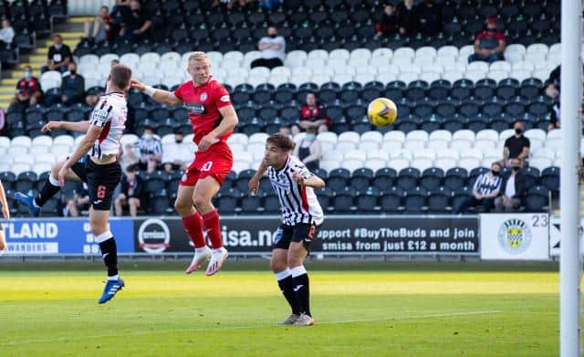 St Mirren striker Curtis Main leaps between Dunfermline duo Kyle Macdonald and Aaron Comrie to score in the Premier Sports Cup match in Paisley. (Photo by Alan Harvey / SNS Group)