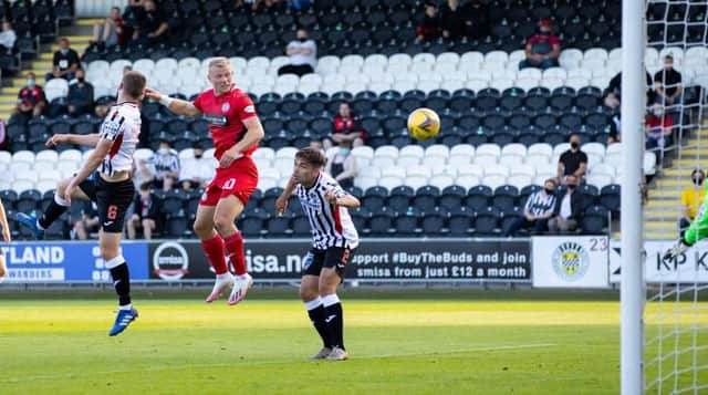 St Mirren striker Curtis Main leaps between Dunfermline duo Kyle Macdonald and Aaron Comrie to score in the Premier Sports Cup match in Paisley. (Photo by Alan Harvey / SNS Group)