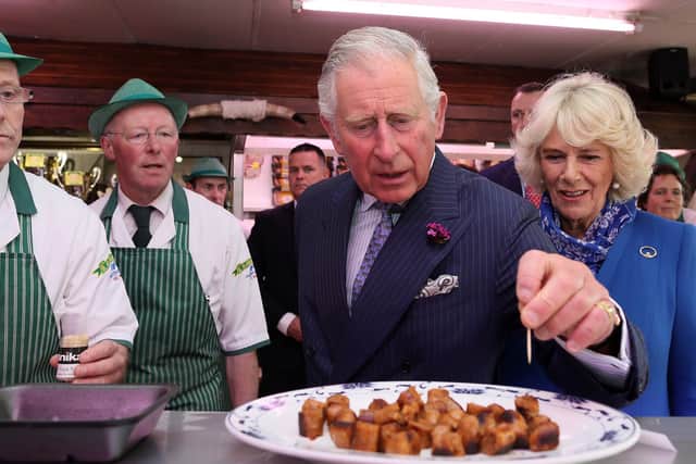 King Charles tries sausages made the traditional way, but would he take to meat grown from stem cells in a lab? (Picture: Paul Faith/WPA pool/Getty Images)