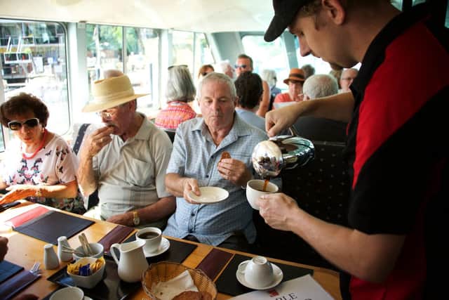 Snacks, meals and drinks are served to tourists taking the mini cruise along the river. Pic: riverboatpostman.com.au