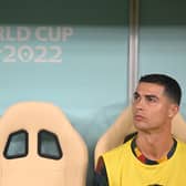 Cristiano Ronaldo sits on the bench during Portugal's 6-1 win over Switzerland in the World Cup last 16 match. (Photo by PATRICIA DE MELO MOREIRA/AFP via Getty Images)