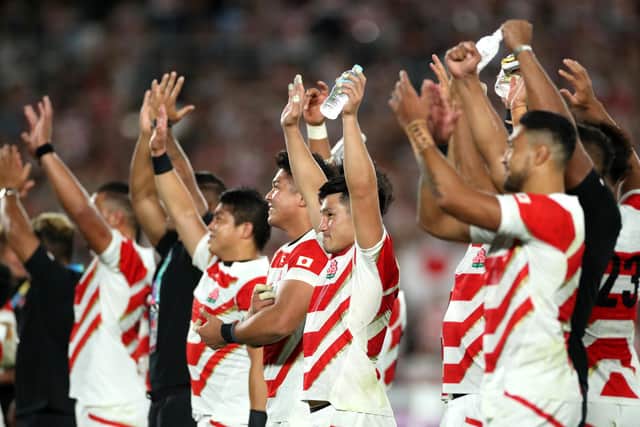 Japan players celebrate reaching the Rugby World Cup quarter-finals for the first time. (Photo by Cameron Spencer/Getty Images)