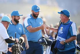 Jon Rahm celebrates with Mick Donaghy, Tyrrell Hatton's caddie, after the  Spaniard almost holed his tee shot at the seventh in the opening session of the 44th Ryder Cup. Picture: Ross Kinnaird/Getty Images.