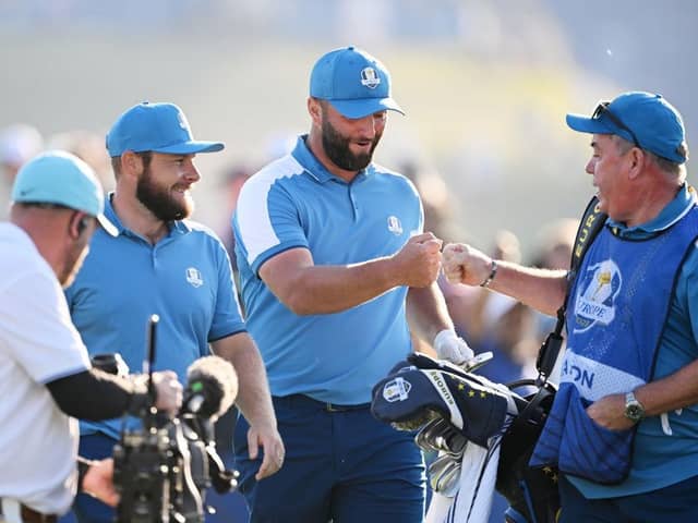 Jon Rahm celebrates with Mick Donaghy, Tyrrell Hatton's caddie, after the  Spaniard almost holed his tee shot at the seventh in the opening session of the 44th Ryder Cup. Picture: Ross Kinnaird/Getty Images.