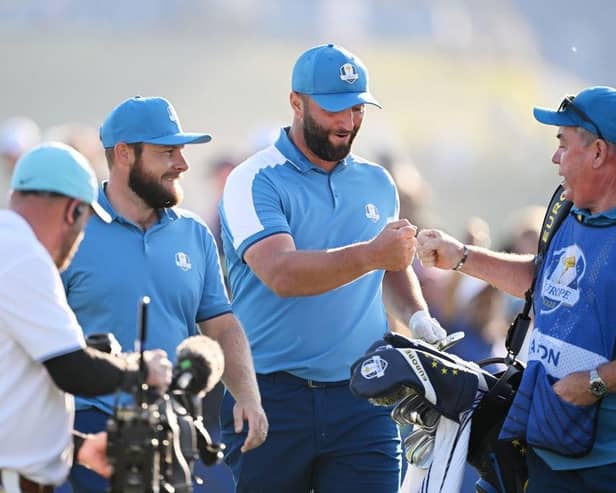 Jon Rahm celebrates with Mick Donaghy, Tyrrell Hatton's caddie, after the  Spaniard almost holed his tee shot at the seventh in the opening session of the 44th Ryder Cup. Picture: Ross Kinnaird/Getty Images.