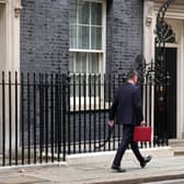 Chancellor Jeremy Hunt leaves Downing Street with the despatch box after presenting his spring budget to parliament