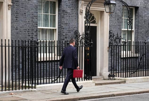 Chancellor Jeremy Hunt leaves Downing Street with the despatch box after presenting his spring budget to parliament
