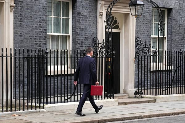 Chancellor Jeremy Hunt leaves Downing Street with the despatch box after presenting his spring budget to parliament