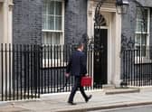 Chancellor Jeremy Hunt leaves Downing Street with the despatch box after presenting his spring budget to parliament