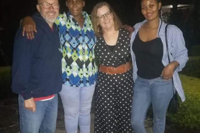 Mark Fleming and his wife Aileen, with their informally adopted daughter, Yvonne, and a translator, in Rwanda.