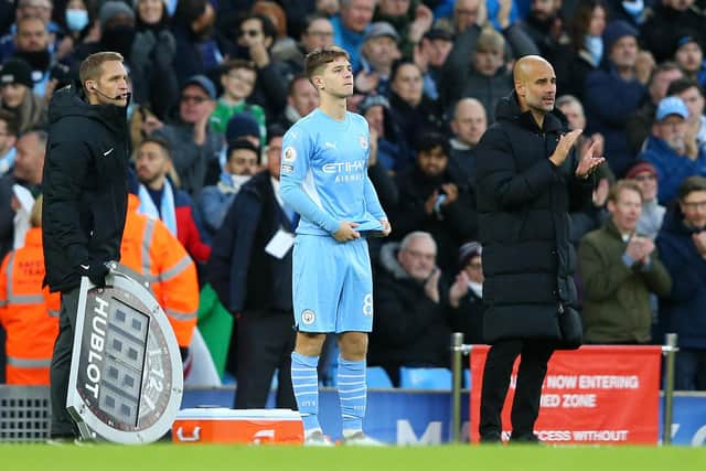 James McAtee with Manchester City manager Pep Guardiola as he prepares to make his Premier League debut for the English champions against Everton in November 2021. (Photo by Alex Livesey/Getty Images)