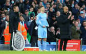 James McAtee with Manchester City manager Pep Guardiola as he prepares to make his Premier League debut for the English champions against Everton in November 2021. (Photo by Alex Livesey/Getty Images)