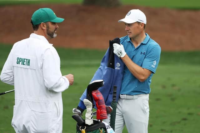 Jordan Spieth talks with his caddie Michael Greller on the practice area at Augusta National Golf Club. Picture: Patrick Smith/Getty Images.