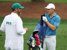 Jordan Spieth talks with his caddie Michael Greller on the practice area at Augusta National Golf Club. Picture: Patrick Smith/Getty Images.