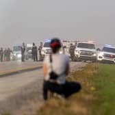 Police and investigators gather at the scene where a stabbing suspect was arrested in Rosthern, Saskatchewan on Wednesday, Sept. 7, 2022. Canadian police arrested Myles Sanderson, the second suspect in the stabbing deaths of multiple people in Saskatchewan, after a three-day manhunt that also yielded the body of his brother fellow suspect, Damien Sanderson.(Heywood Yu/The Canadian Press via AP)