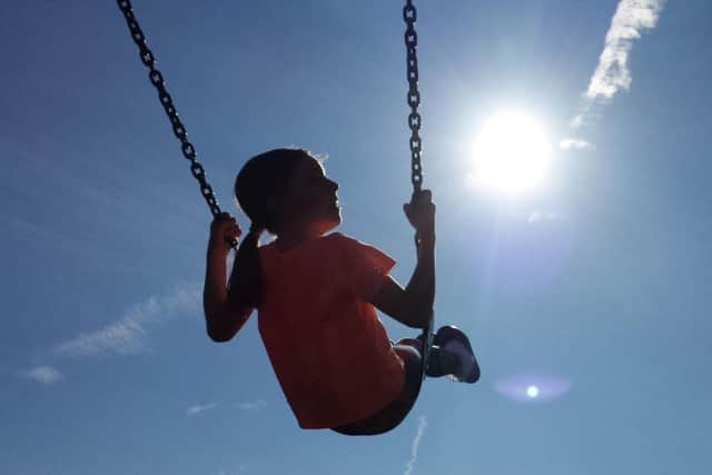 A child enjoying a swing. The full rollout of a benefit payment to low-income families in Scotland has been hailed as a "watershed moment". Picture: Peter Byrne/PA Wire