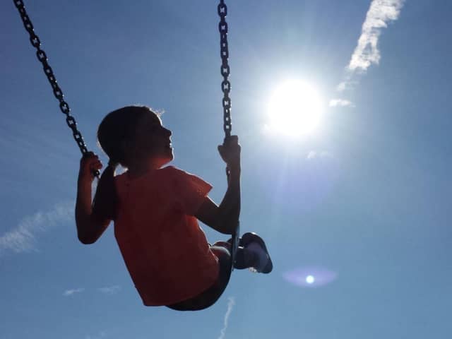 A child enjoying a swing. The full rollout of a benefit payment to low-income families in Scotland has been hailed as a "watershed moment". Picture: Peter Byrne/PA Wire
