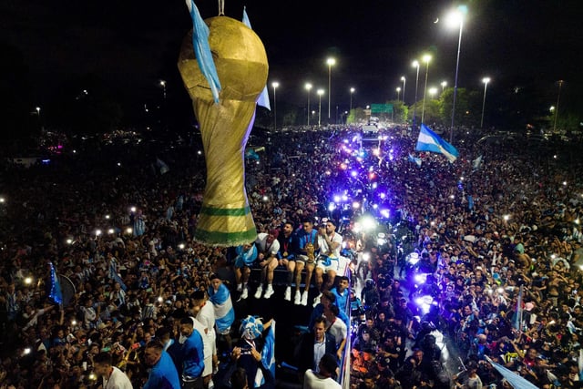 The bus moved at a snail’s pace as fans, many of whom were waving Argentine flags, swarmed towards it, eager for a glimpse of the players as law enforcement officers tried to keep them at bay.