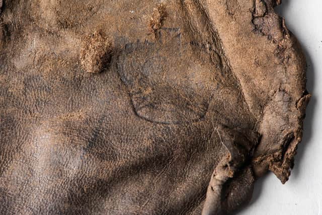 A leather pouch embossed with the Crown  was also found among the wreckage of HMS Gloucester. PIC: Norfolk Museum Service.