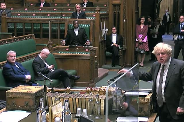Boris Johnson, seen speaking in the House of Commons, watched by SNP Westminster leader Ian Blackford, left, still commands considerable support -- south of the Border (Picture:  House of Commons/PA)