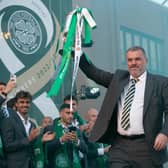 Ange Postecoglou lifts the Scottish Cup outside Celtic Park as fans congregate to celebrate the treble. (Photo by Ewan Bootman / SNS Group)