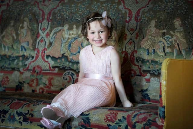 Five year-old Mila Sneddon, a cancer patient who featured in an image from the Hold Still photography project which showed her kissing her father Scott through a window whilst she was shielding during her chemotherapy treatment, waits to meet Britain's Catherine, Duchess of Cambridge at the Palace of Holyroodhouse in Edinburgh, Scotland on May 27, 2021.