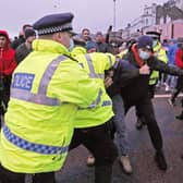 Police hold back drivers trying to enter the Port of Dover in Kent after French authorities announced that the coronavirus ban was lifted and journeys from the UK will be allowed to resume, but that those seeking to travel must have a negative test result.