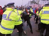 Police hold back drivers trying to enter the Port of Dover in Kent after French authorities announced that the coronavirus ban was lifted and journeys from the UK will be allowed to resume, but that those seeking to travel must have a negative test result.