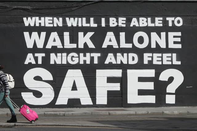 A member of the public walks past the latest mural by Irish artist Emmalene Blake in Dublin's city centre. The inscription 'When will I be able to walk alone at night and feel safe?' relates to violence against women in the wake of the death of Sarah Everard.  Picture date: Monday March 29, 2021. PA Photo. Photo credit : Niall Carson/PA Wire