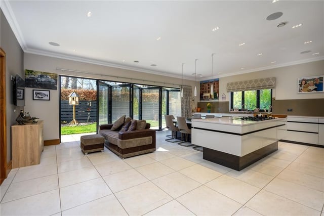 Kitchen/dining/family room with glass bi-fold doors into the gardens.