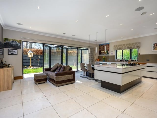 Kitchen/dining/family room with glass bi-fold doors into the gardens.