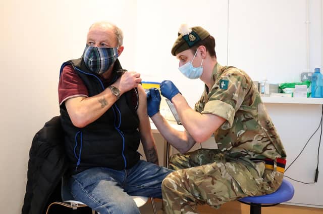 Derek Fraser from Edinburgh receives an injection of a coronavirus vaccine from military doctor Captain Robert Reid from 3 Medical Regiment who are assisting with the vaccination programme at the Royal Highland Showground near Edinburgh