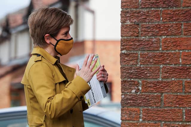 First Minister Nicola Sturgeon speaks to a member of the public. Picture: Russell Cheyne - Pool/Getty Images
