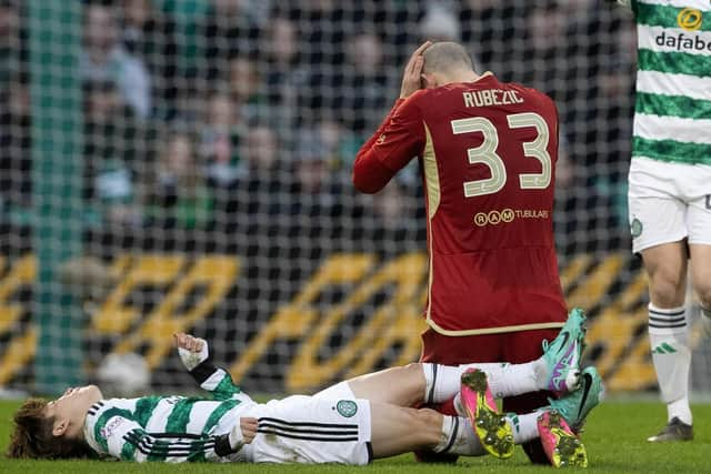 Aberdeen's Slobodan Rubezic and Furuhashi collide heads.