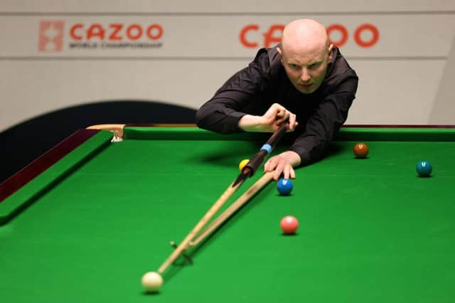 Anthony McGill of Scotland plays a shot during their round two match against Jack Lisowski of England on Day Nine of the Cazoo World Snooker Championship 2023 at the Crucible Theatre in Sheffield.