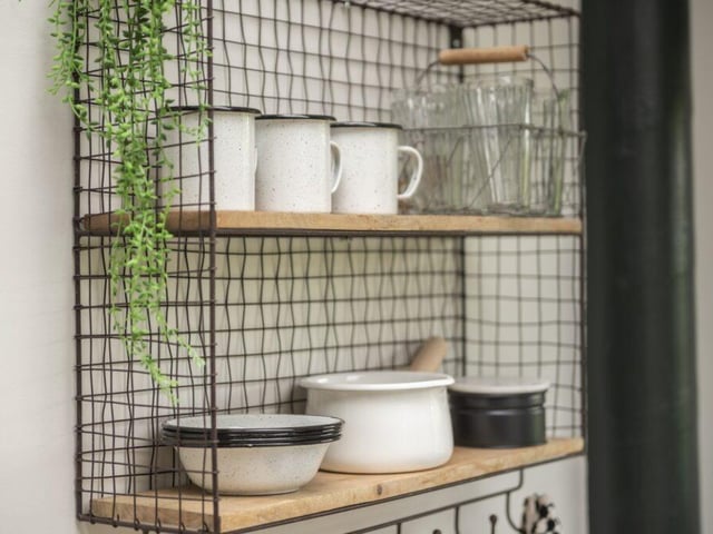 The kitchen comes with cooking implements, knives, chopping boards, cast iron pans, enamel crockery, glasses, cutlery, condiments, and cleaning equipment.