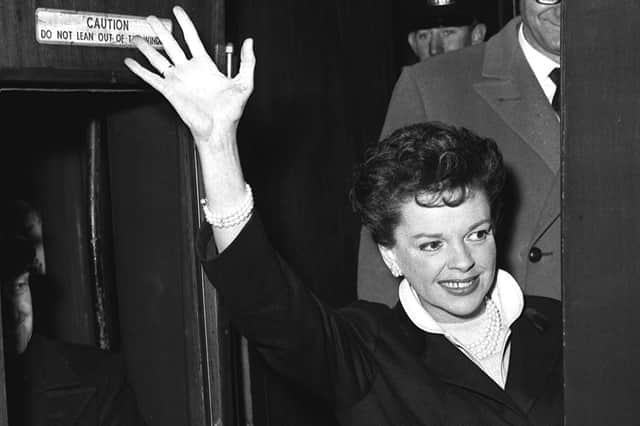 An emotional rendition of Have Yourself a Merry Little Christmas in a 1944 film by Judy Garland, pictured waving to onlookers at London's St Pancras Station in 1963, resonates strongly today as we face the Covid crisis but with hope for the future (Picture: PA)