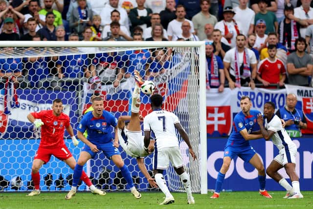 Jude Bellingham scores an overhead kick in the fifth minute of stoppage time to save England from a 1-0 defeat to Slovakia at Euro 2024. (Photo by Carl Recine/Getty Images)