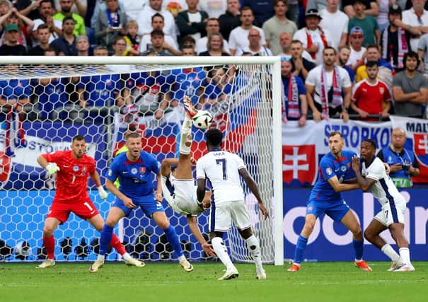 Jude Bellingham scores an overhead kick in the fifth minute of stoppage time to save England from a 1-0 defeat to Slovakia at Euro 2024. (Photo by Carl Recine/Getty Images)
