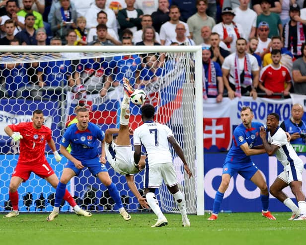 Jude Bellingham scores an overhead kick in the fifth minute of stoppage time to save England from a 1-0 defeat to Slovakia at Euro 2024. (Photo by Carl Recine/Getty Images)