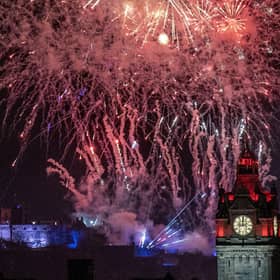 Fireworks explode over Edinburgh Castle and the Balmoral Hotel during Edinburgh's Hogmanay street party. Picture: Jane Barlow/PA Wire